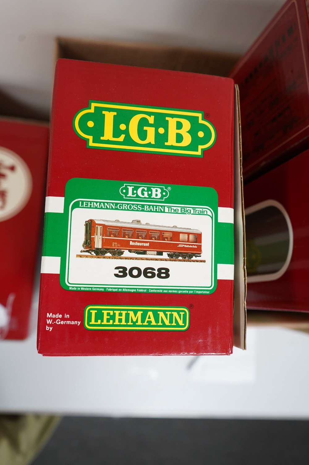 Three boxed LGB G scale Continental outline RhB bogie coaches; a Full First (30650), a restaurant car (3068), and another Full First (3067). Condition - good.